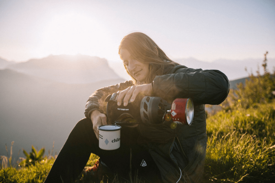 femme montagne assise café réchaud